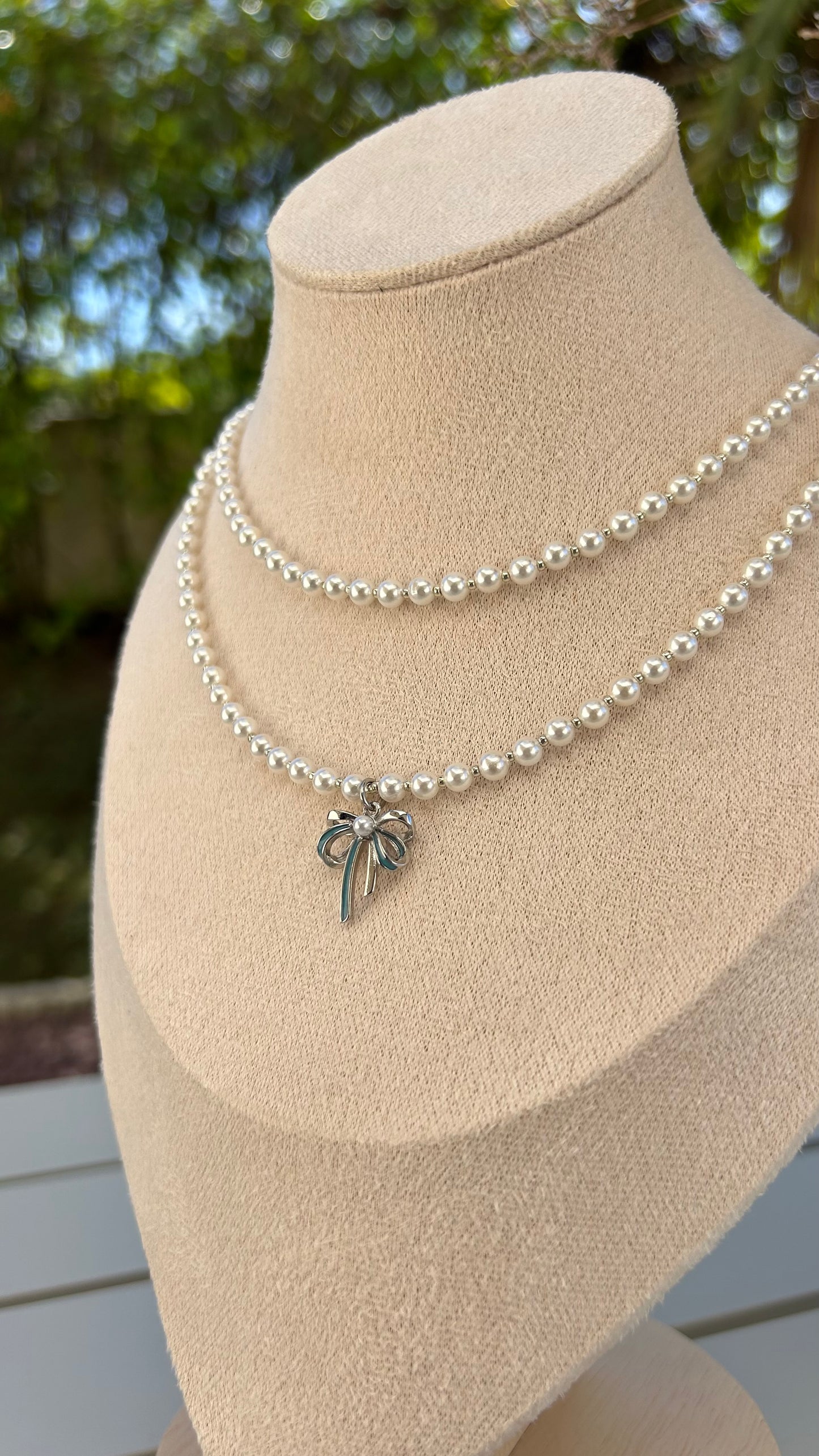 Grace in Every Detail: Pearl Necklace with Silver Bow Charm